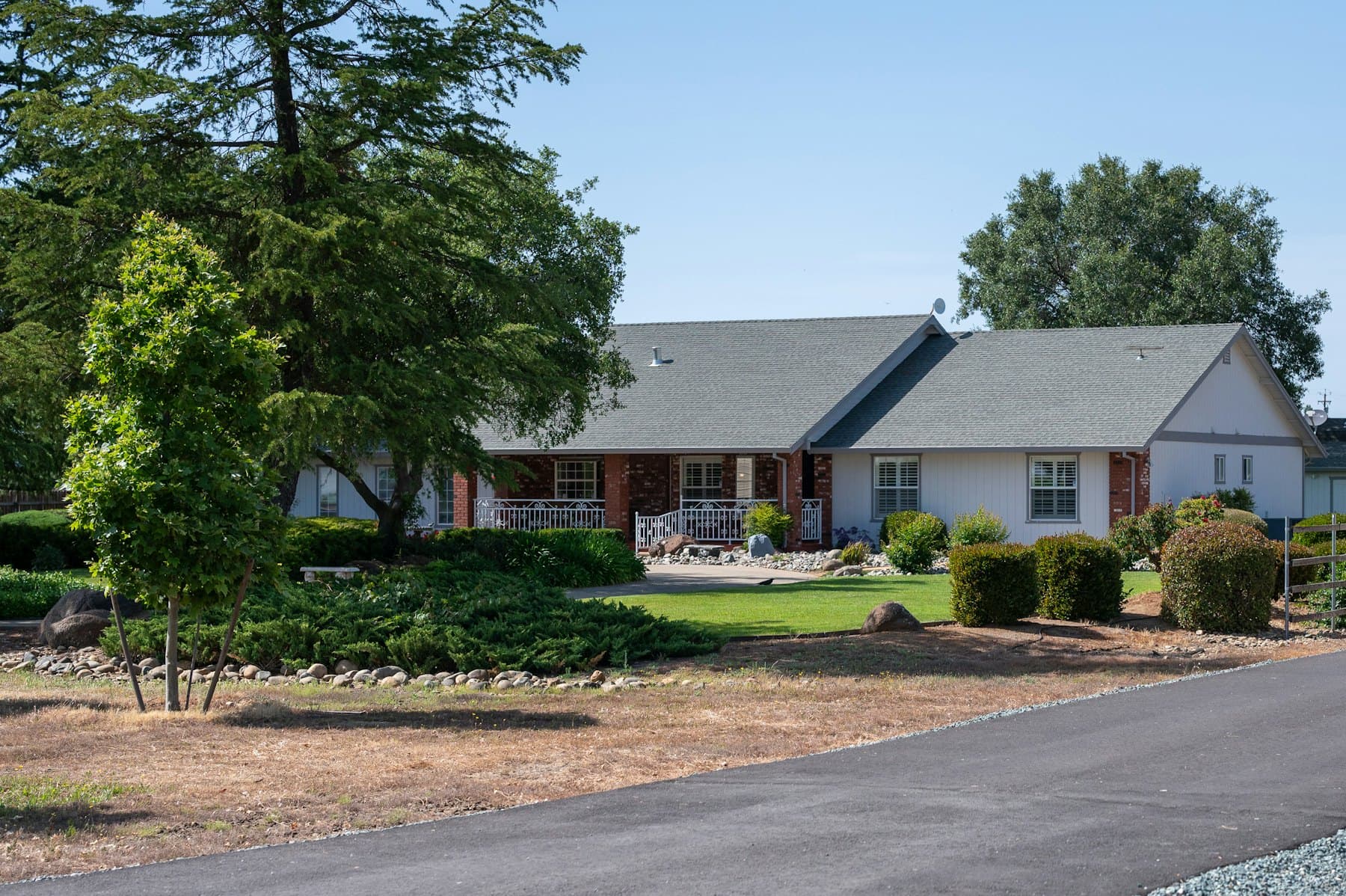 Single-story brick house with a green lawn
